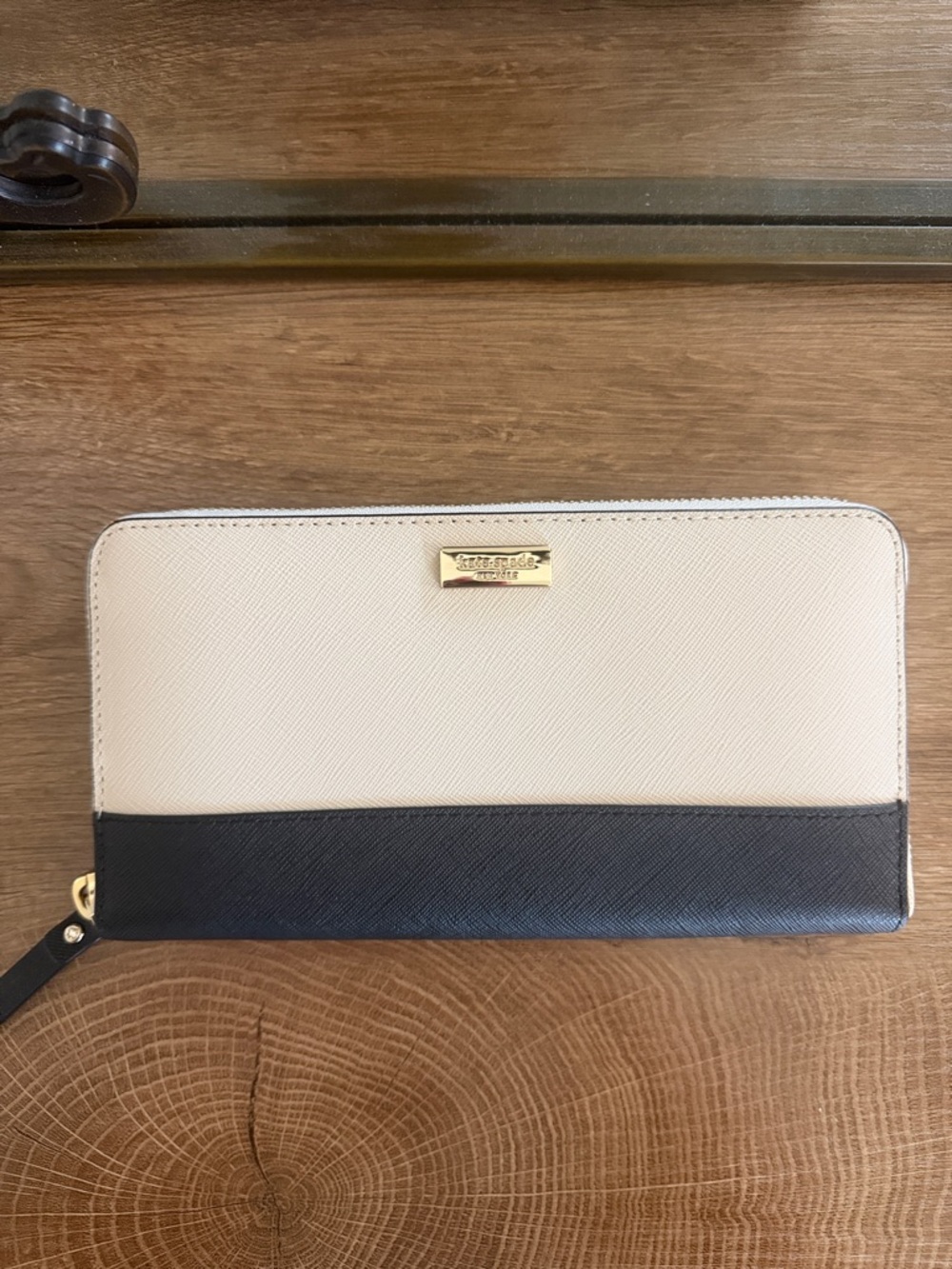 kate spade beige and black zip-around wallet with gold logo